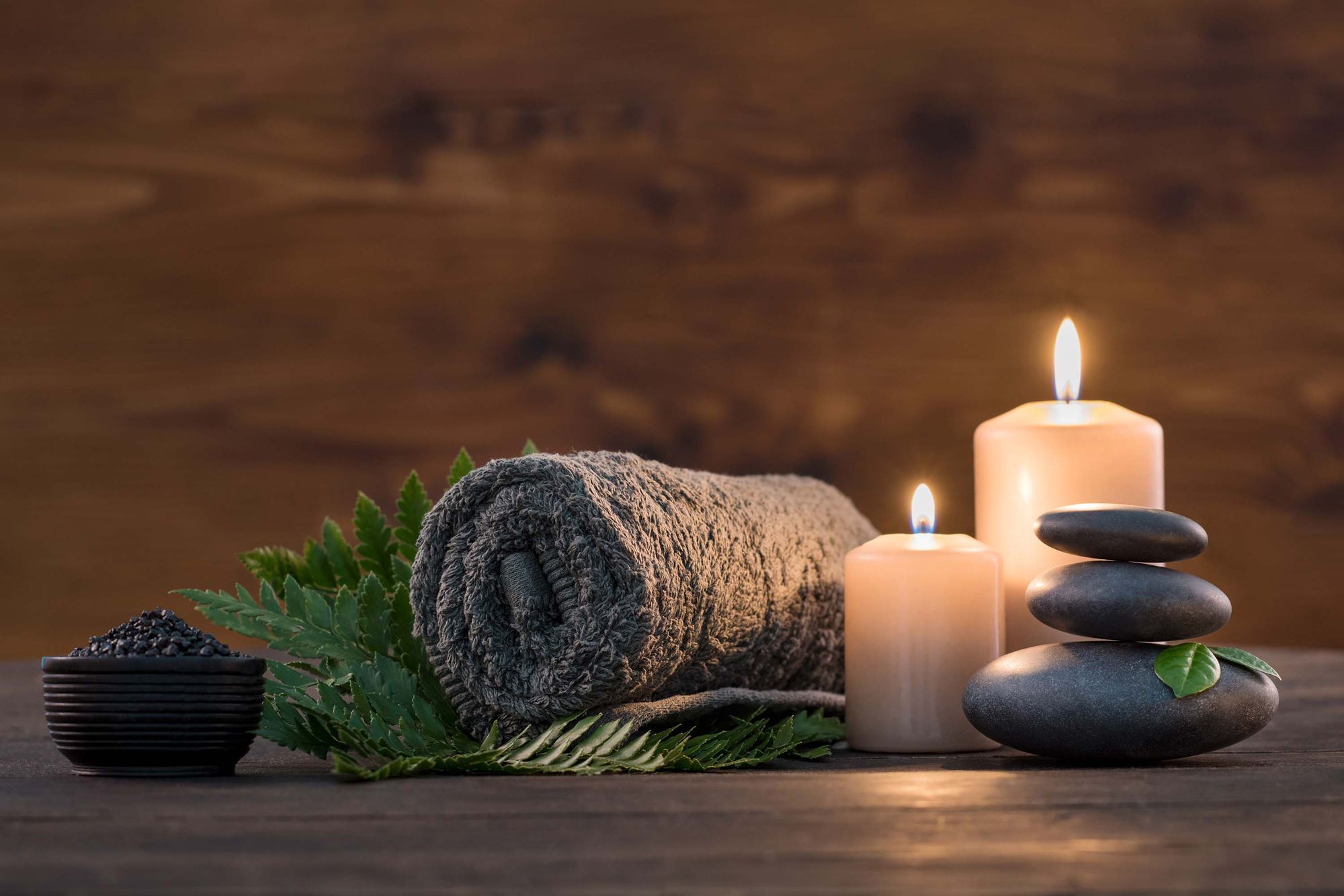 Candles, hot stones and a rolled towel